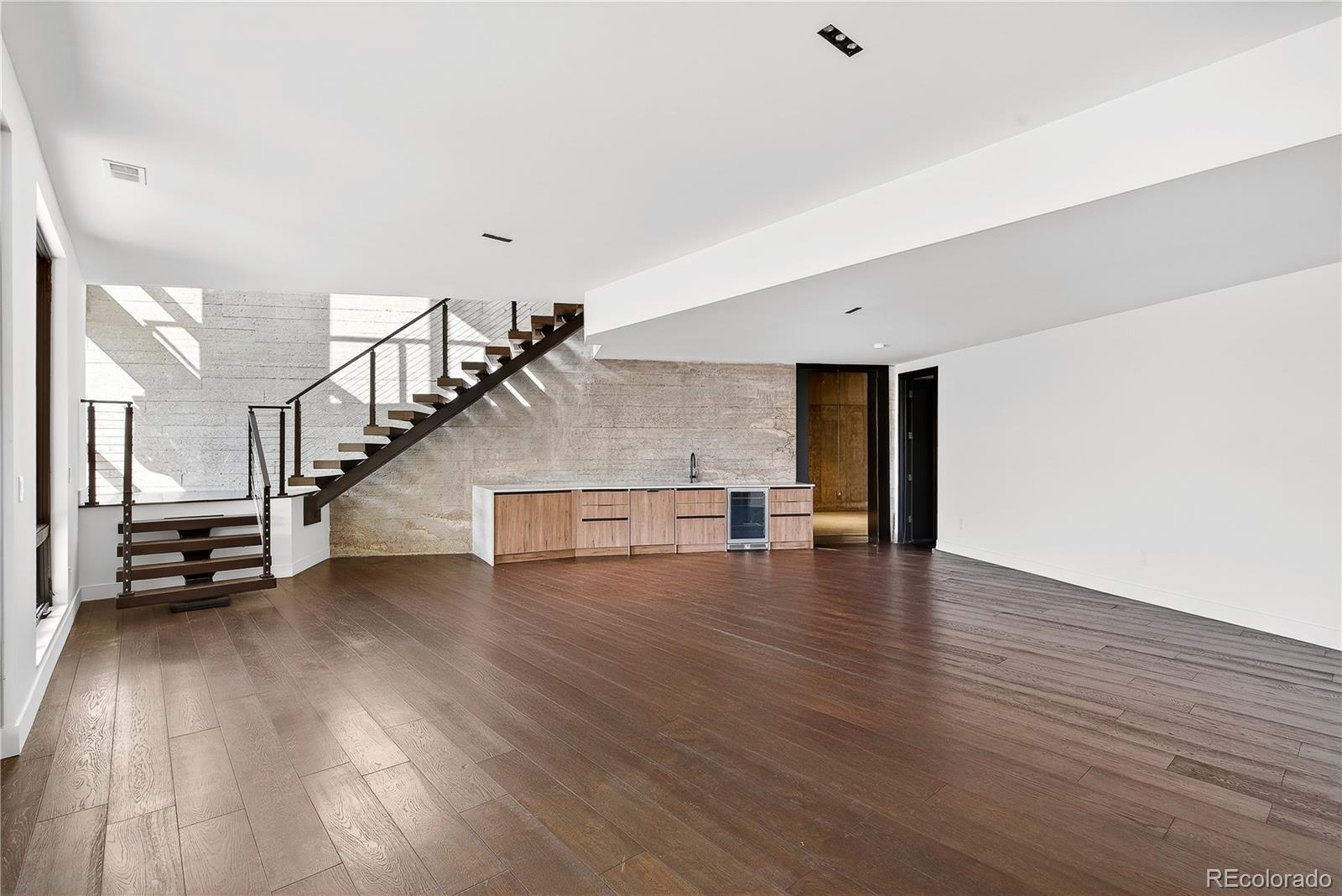 545 Strada Rossa Road Golden, CO 80401 - Photo 44 of 49 a view of a livingroom with wooden floor and stairs