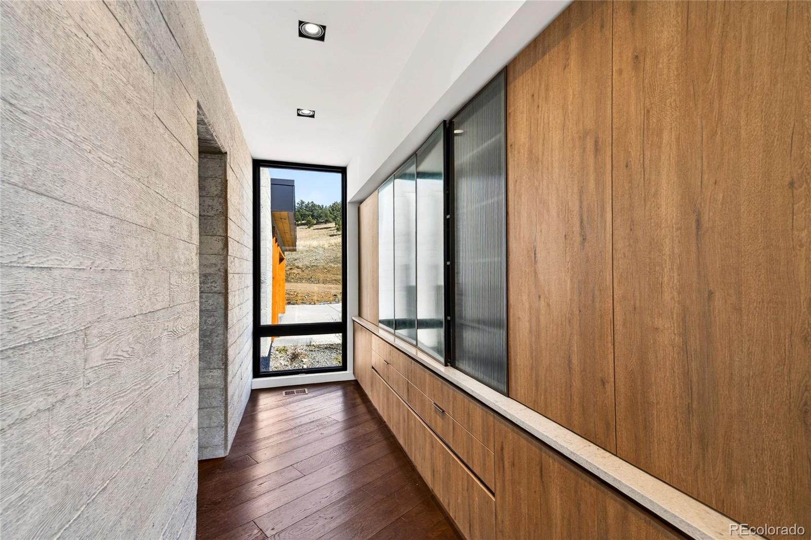 545 Strada Rossa Road Golden, CO 80401 - Photo 7 of 49 a view of a hallway with wooden floor and staircase