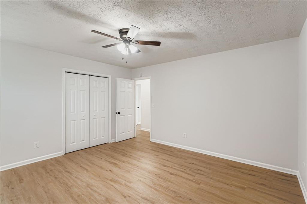 862 Sheppard Way Stone Mountain, GA 30083 - Photo 11 of 22 a view of an empty room with wooden floor