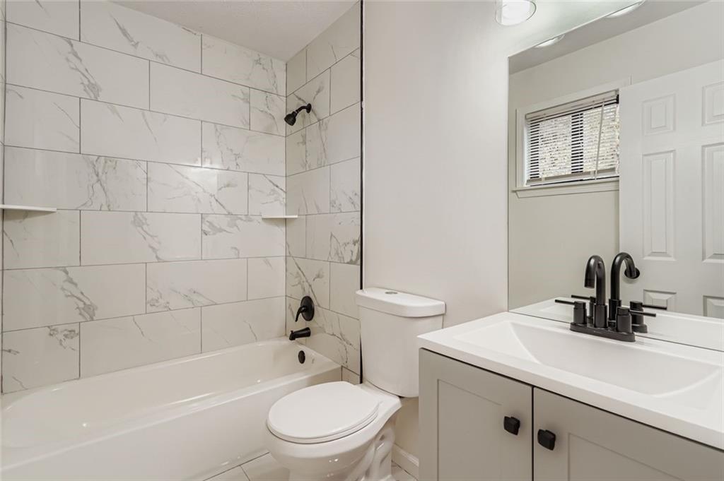 862 Sheppard Way Stone Mountain, GA 30083 - Photo 12 of 22 a bathroom with a sink a toilet and shower