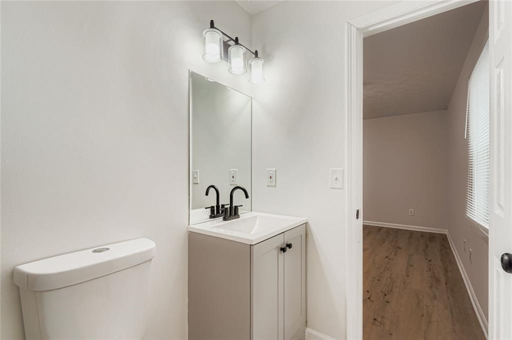 862 Sheppard Way Stone Mountain, GA 30083 - Photo 13 of 22 a bathroom with a sink a toilet and a mirror