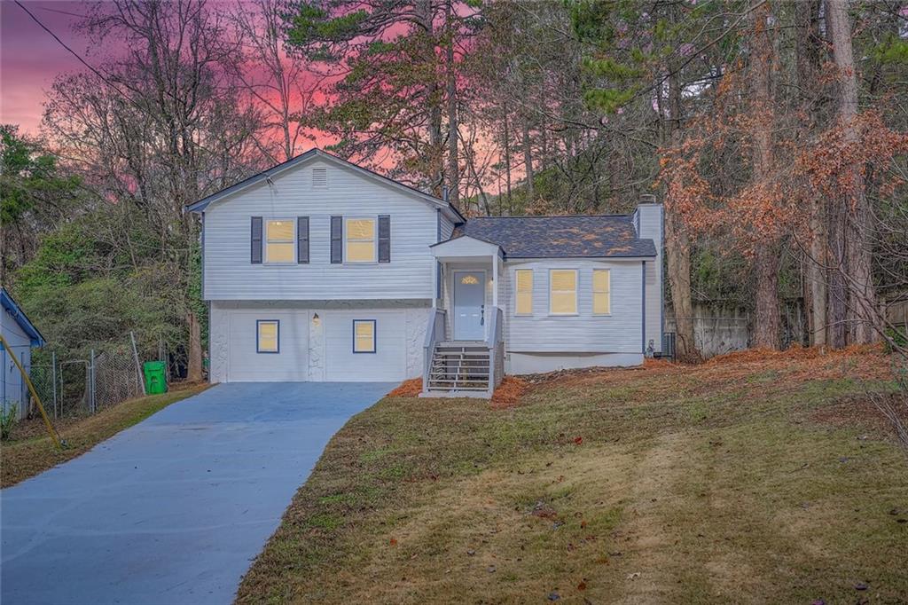 862 Sheppard Way Stone Mountain, GA 30083 - Photo 22 of 22 a front view of a house with a yard and garage