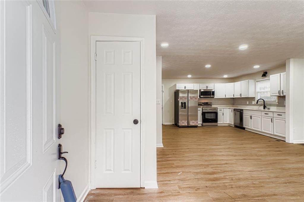 862 Sheppard Way Stone Mountain, GA 30083 - Photo 3 of 22 a view of kitchen with refrigerator and white cabinets