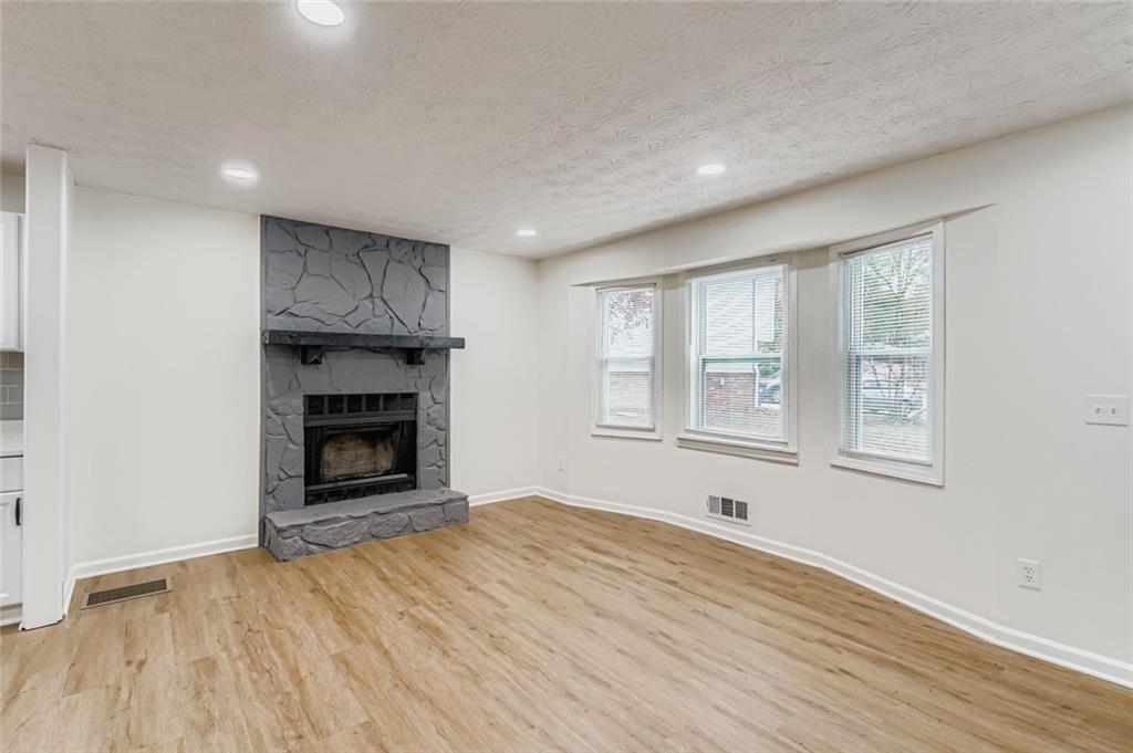 862 Sheppard Way Stone Mountain, GA 30083 - Photo 7 of 22 wooden floor in an empty room with a window