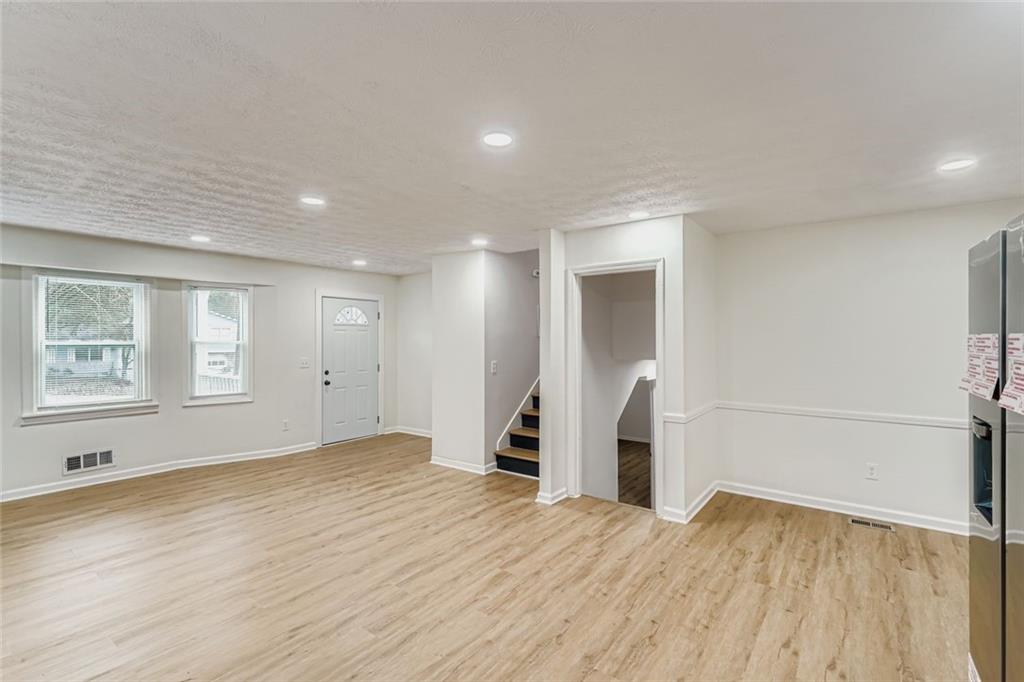 862 Sheppard Way Stone Mountain, GA 30083 - Photo 9 of 22 a view of empty room with wooden floor and window
