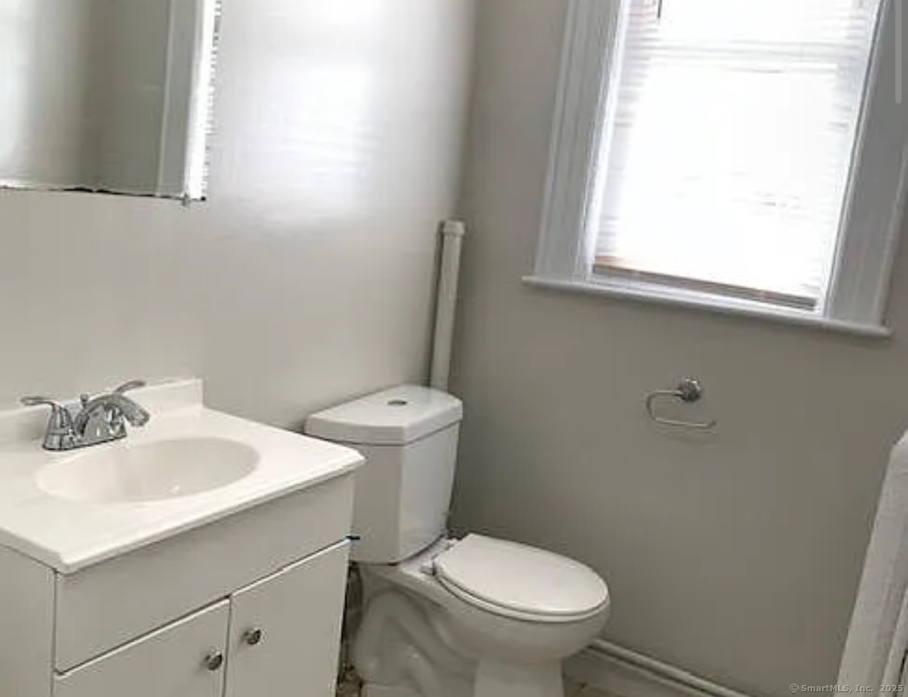 1589 Fairfield Avenue, Unit 7 Bridgeport, CT 06605 - Photo 3 of 3 a bathroom with a sink a toilet and a mirror