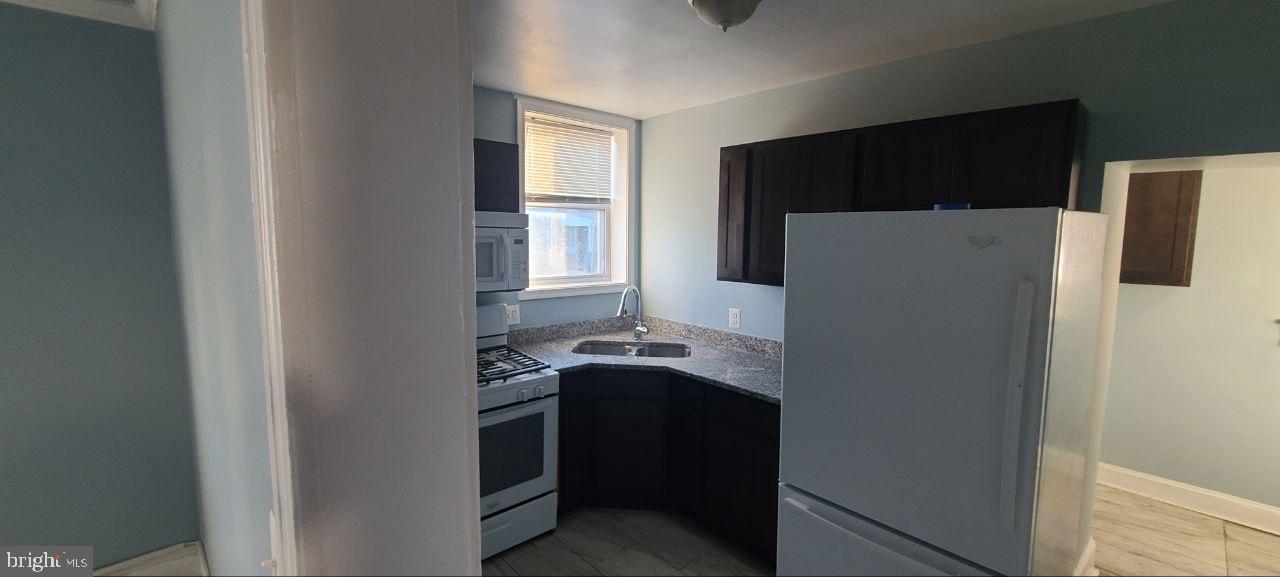 4700 York Road, Unit 2 Baltimore, MD 21212 - Photo 11 of 12 a kitchen with a refrigerator and a sink