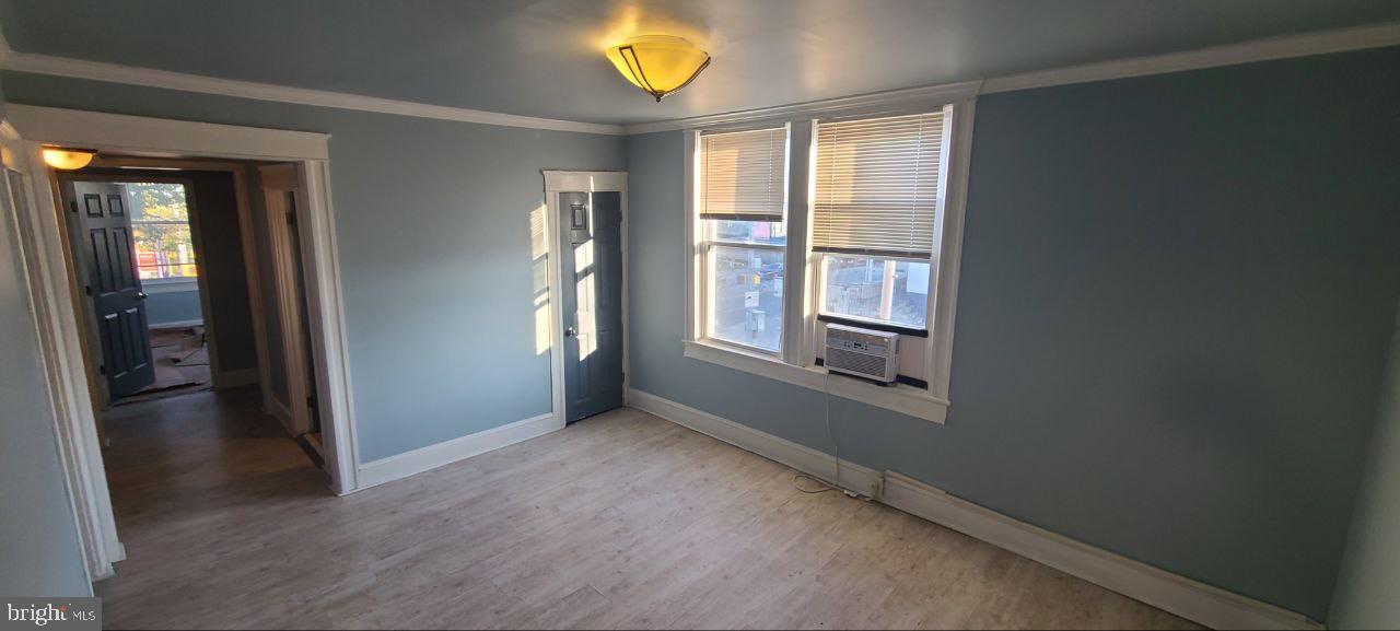 4700 York Road, Unit 2 Baltimore, MD 21212 - Photo 10 of 12 an empty room with windows and entrance