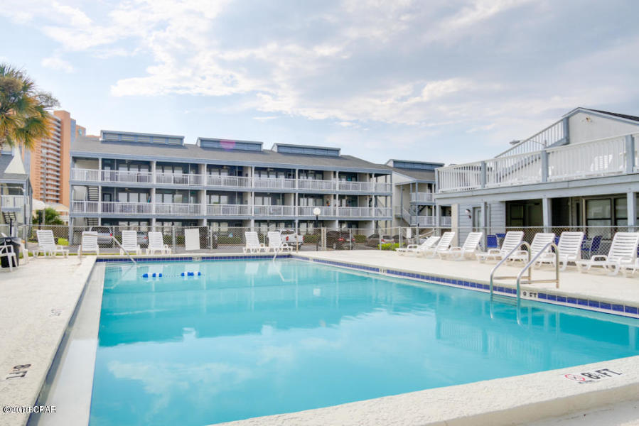 17670 Front Beach Road, Unit D3 Panama City Beach, FL 32413 - Photo 12 of 12 a view of a swimming pool with a lounge chair