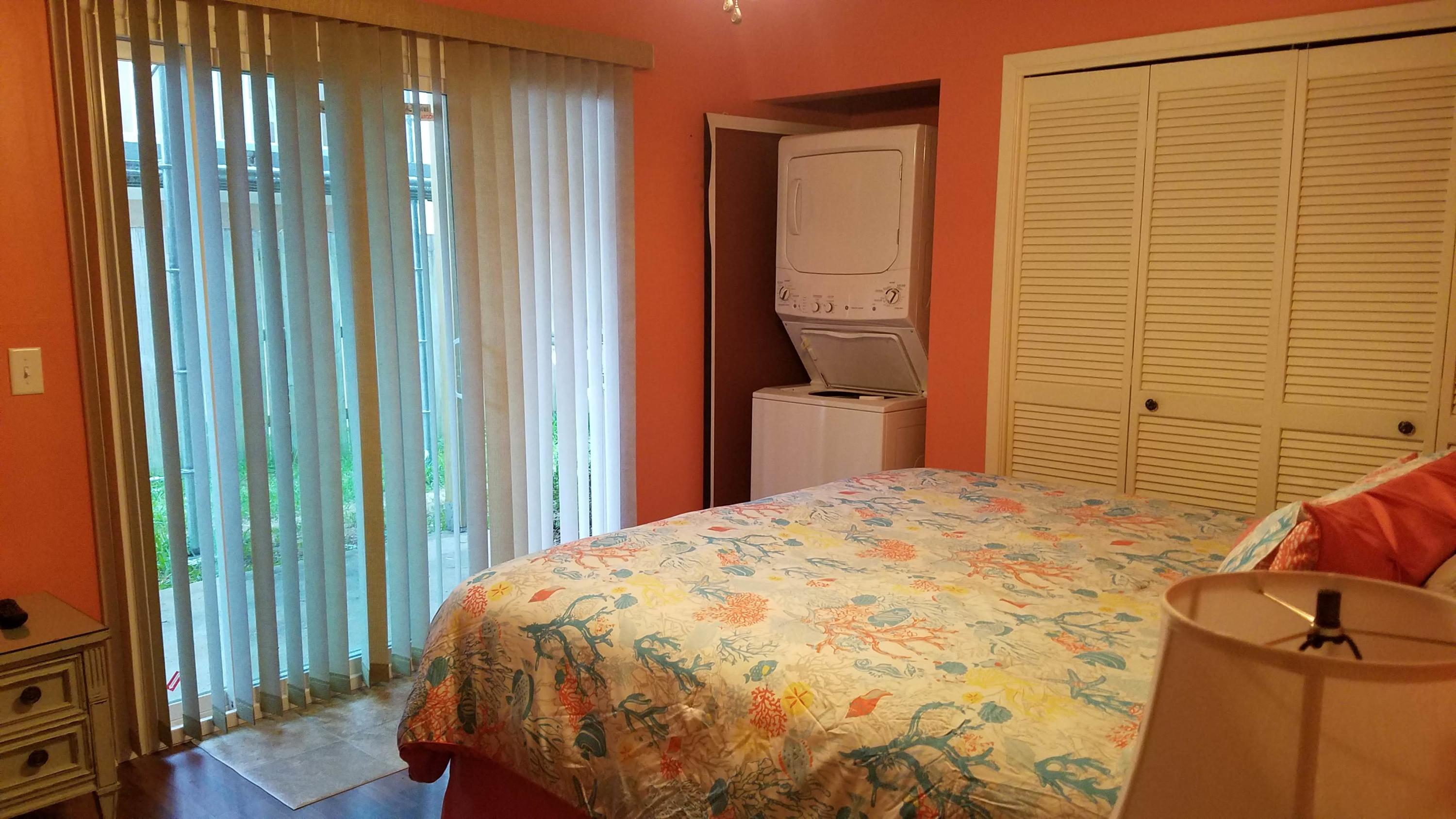 17670 Front Beach Road, Unit D3 Panama City Beach, FL 32413 - Photo 7 of 12 a bedroom with a bed and wooden floor