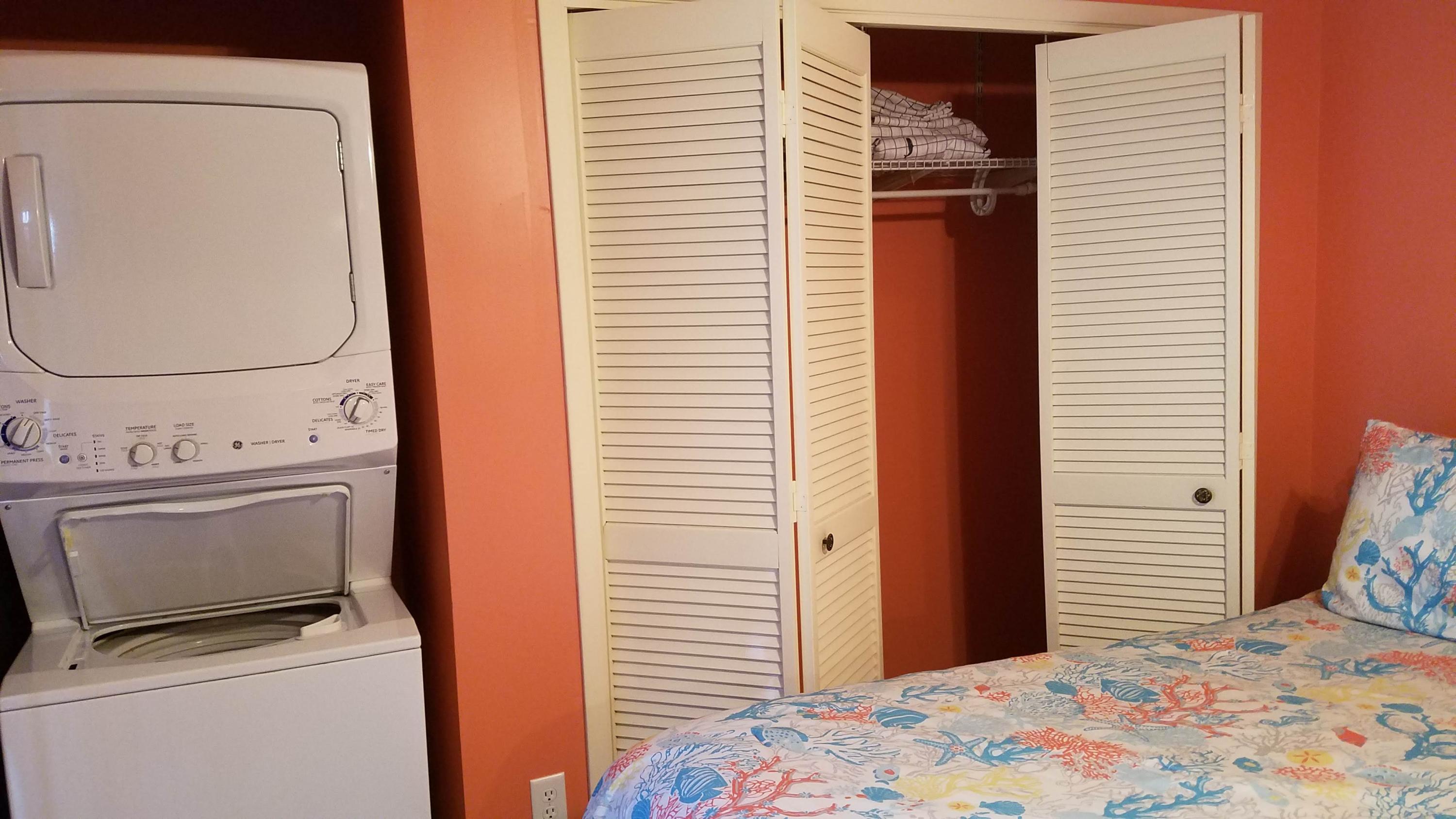 17670 Front Beach Road, Unit D3 Panama City Beach, FL 32413 - Photo 8 of 12 a bedroom with a bed and utility room