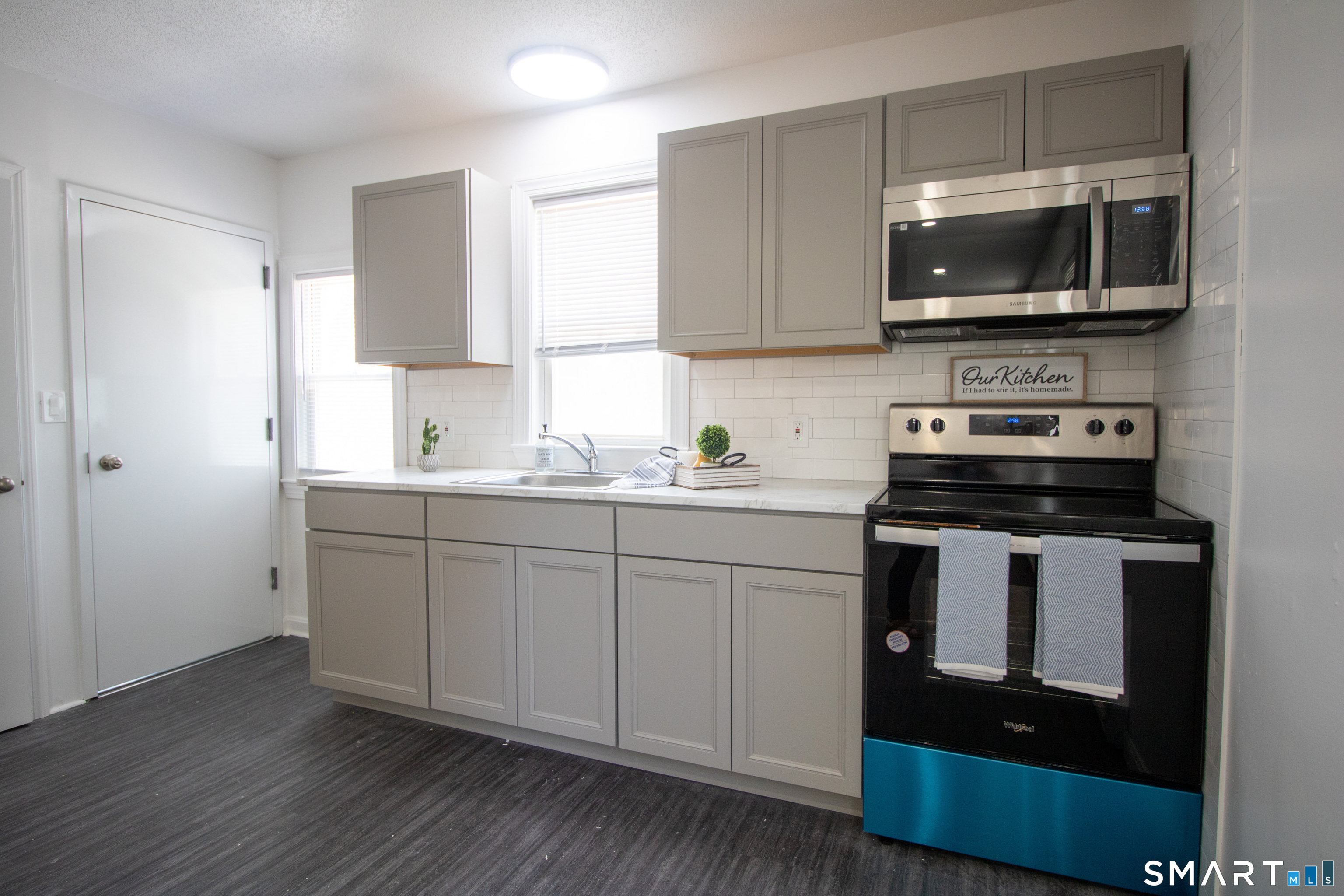 12 Home Street, Unit 2 New London, CT 06320 - Photo 1 of 1 a kitchen with stainless steel appliances granite countertop a stove a sink and a microwave