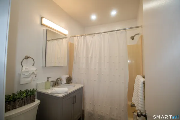 a bathroom with a sink a mirror and a shower