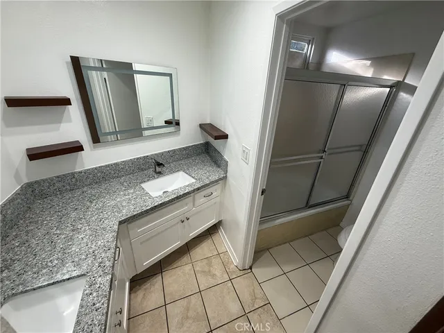 a bathroom with a sink a mirror and vanity