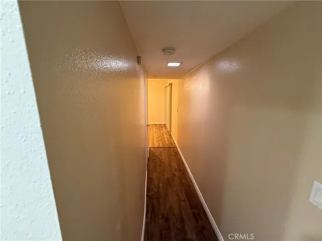 a view of hallway with wooden floor
