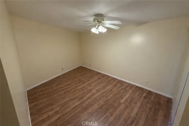 a view of a room with wooden floor and chandelier