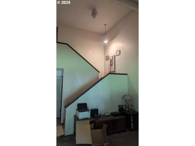 a living room with furniture and stairs