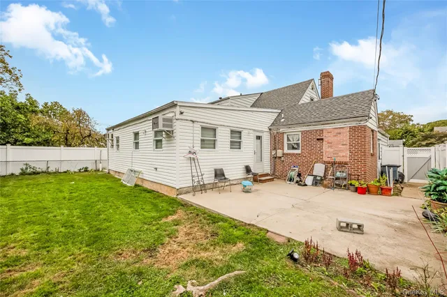 a front view of a house with yard patio and fire pit