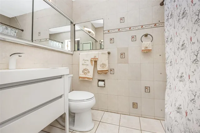 a bathroom with a toilet sink and shower