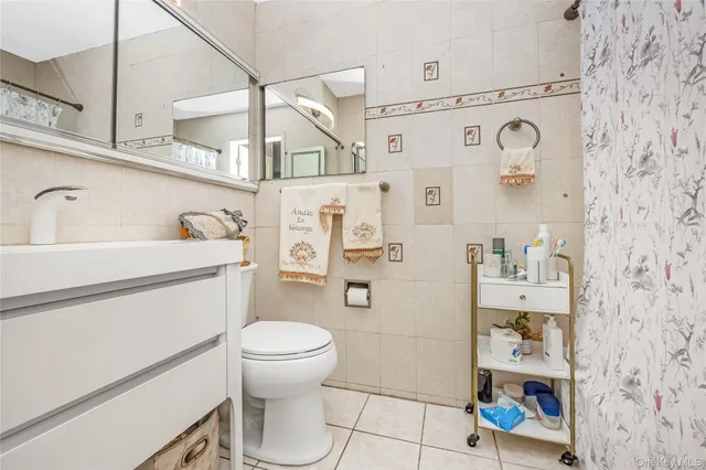 a bathroom with a sink a toilet and a shower curtain