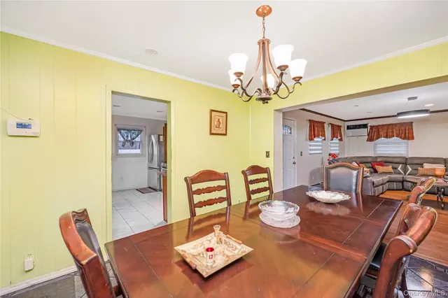 a view of a dining room with furniture and chandelier