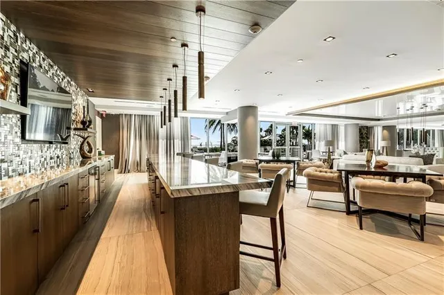 a large kitchen with a table and chairs