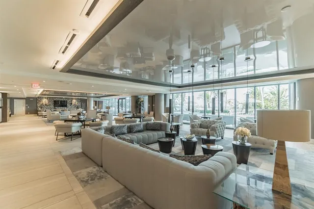 a living room with fireplace furniture and a large window