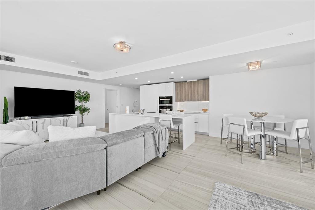 730 North Ocean Boulevard, Unit 1201 Pompano Beach, FL 33062 - Photo 28 of 40 a living room with furniture and a flat screen tv