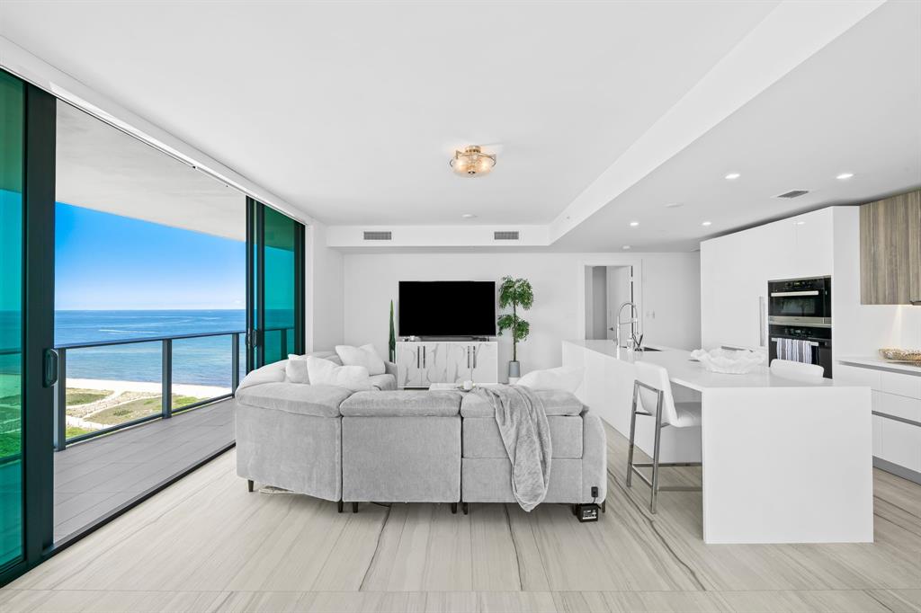 730 North Ocean Boulevard, Unit 1201 Pompano Beach, FL 33062 - Photo 29 of 40 a living room with furniture and a flat screen tv