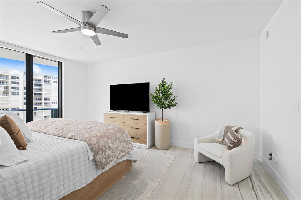 730 North Ocean Boulevard, Unit 1201 Pompano Beach, FL 33062 - Photo 34 of 40 a bedroom with a bed and a flat screen tv