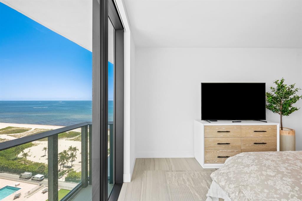 730 North Ocean Boulevard, Unit 1201 Pompano Beach, FL 33062 - Photo 36 of 40 a living room with a flat screen tv and a floor to ceiling window