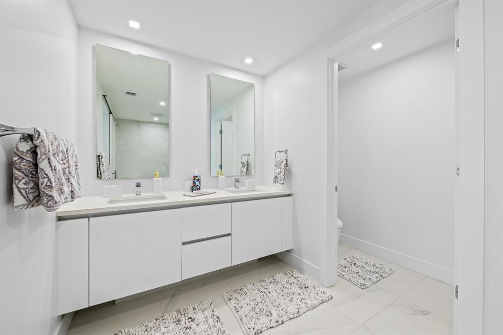 730 North Ocean Boulevard, Unit 1201 Pompano Beach, FL 33062 - Photo 39 of 40 a bathroom with a double vanity sink and a mirror