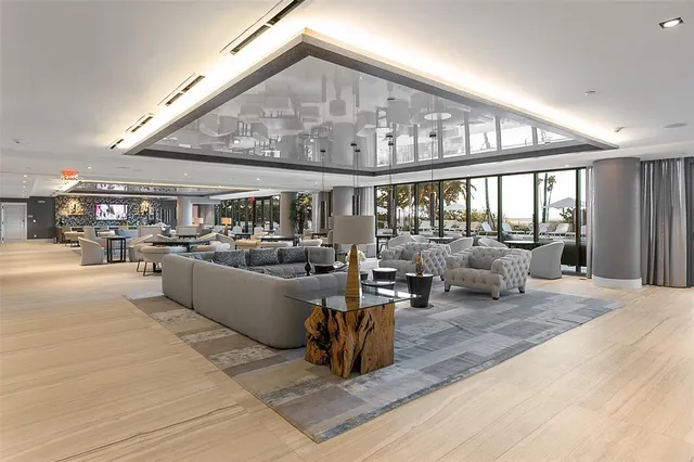 a living room with lots of furniture and kitchen view