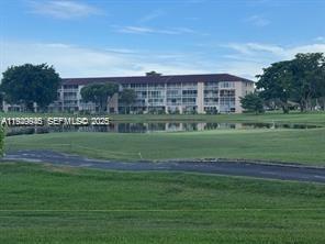 13550 Southwest 6th Court, Unit 113A Pembroke Pines, FL 33027 - Photo 11 of 12 a view of a big building with a big yard