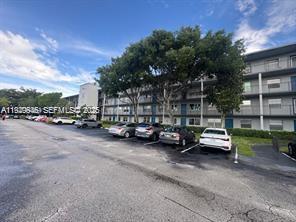 13550 Southwest 6th Court, Unit 113A Pembroke Pines, FL 33027 - Photo 10 of 12 a view of car parked in front of house