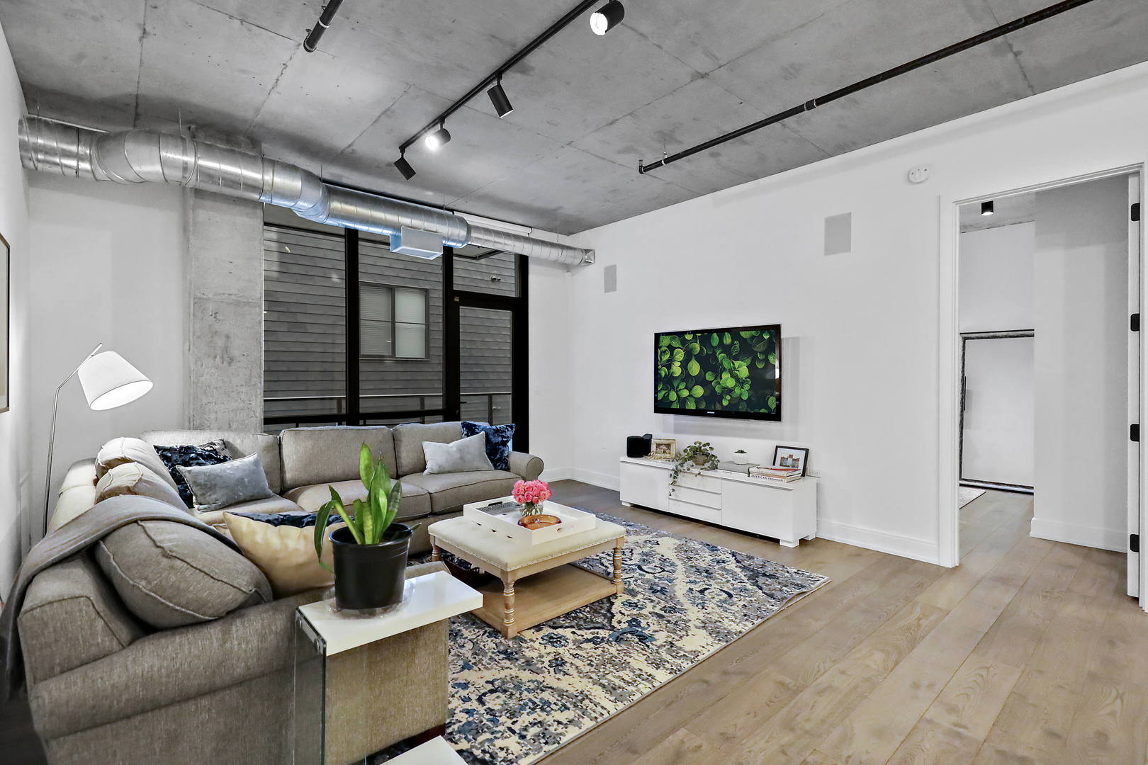 111 South Peoria Street, Unit 406 Chicago, IL 60607 - Photo 11 of 26 a living room with furniture and a flat screen tv