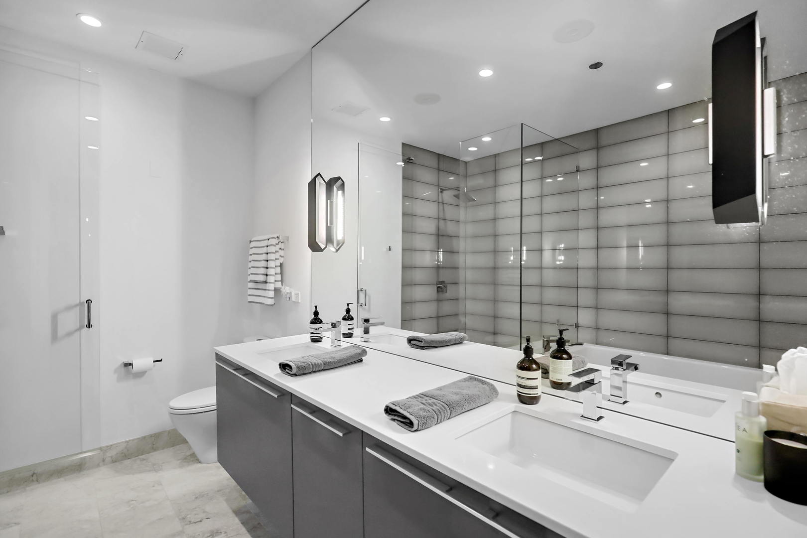 111 South Peoria Street, Unit 406 Chicago, IL 60607 - Photo 21 of 26 a bathroom with a sink double vanity and a toilet