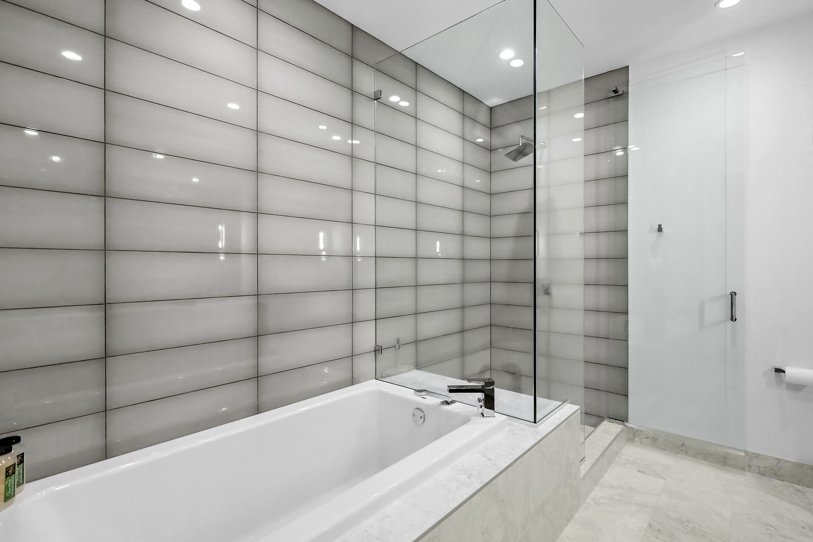 111 South Peoria Street, Unit 406 Chicago, IL 60607 - Photo 22 of 26 a bathroom with a bathtub and shower