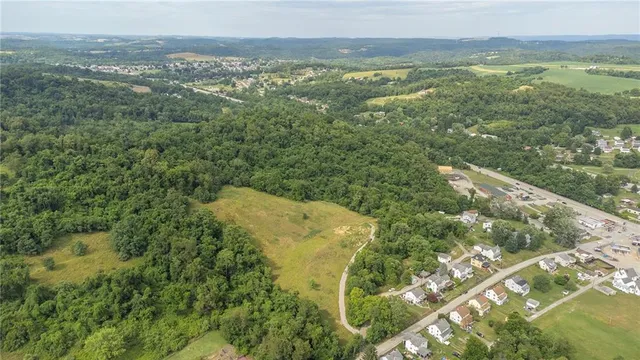an aerial view of a houses with a yard