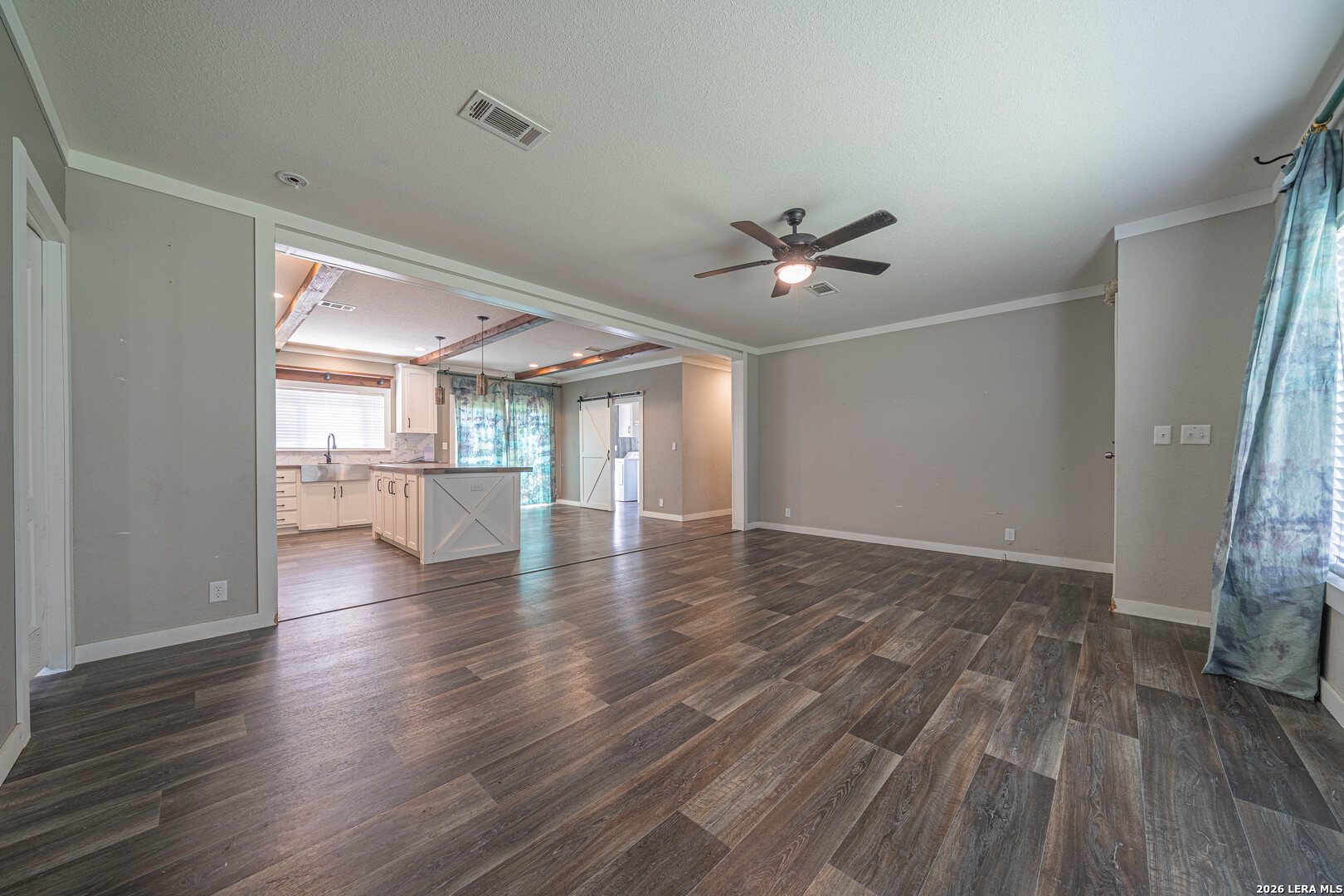 3433 Gander Slough Road Kingsbury, TX 78638 - Photo 8 of 23 a view of an empty room with wooden floor and a ceiling fan
