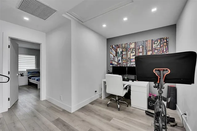 a view of workspace with wooden floor windows