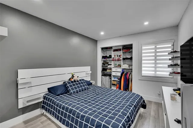 a bedroom with a bed and a book shelf