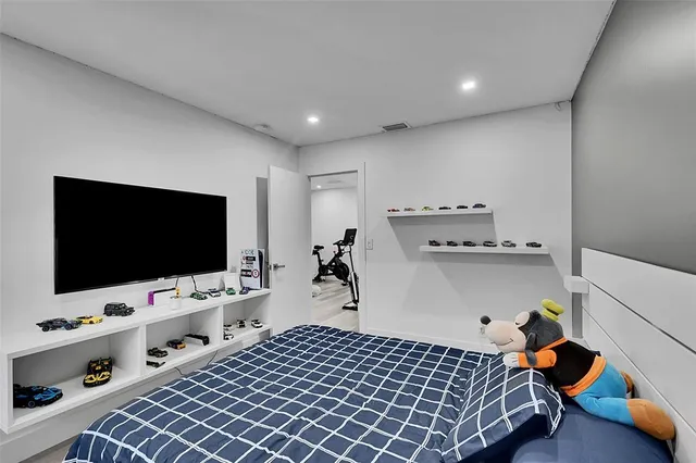 a bedroom with furniture and a flat screen tv