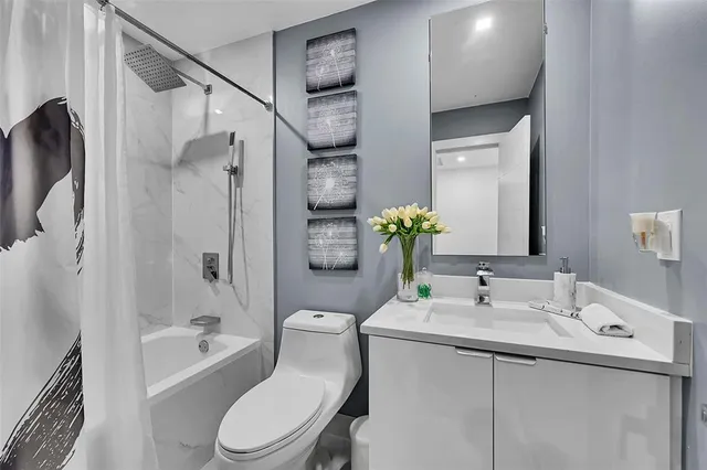 a bathroom with a sink toilet and shower
