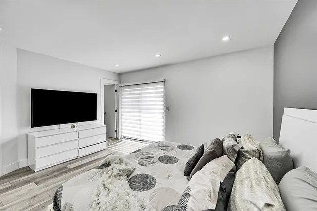 a bedroom with a bed and a flat screen tv