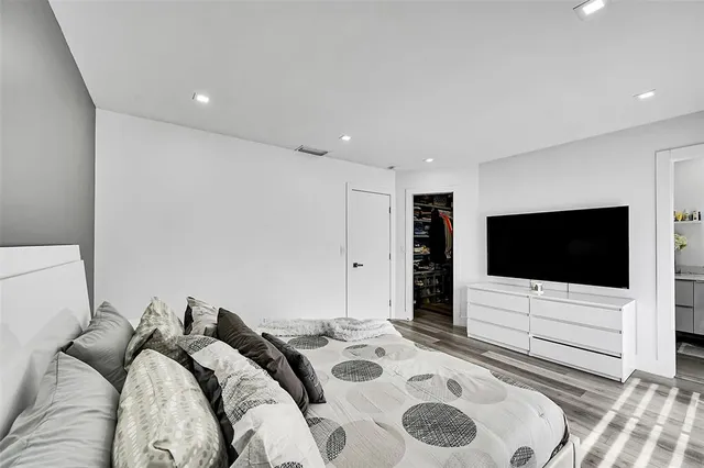 a bedroom with a bed and a flat screen tv