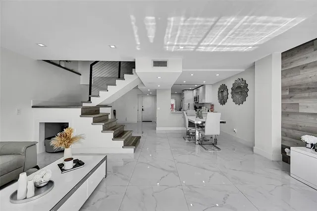 a living room with furniture and kitchen view