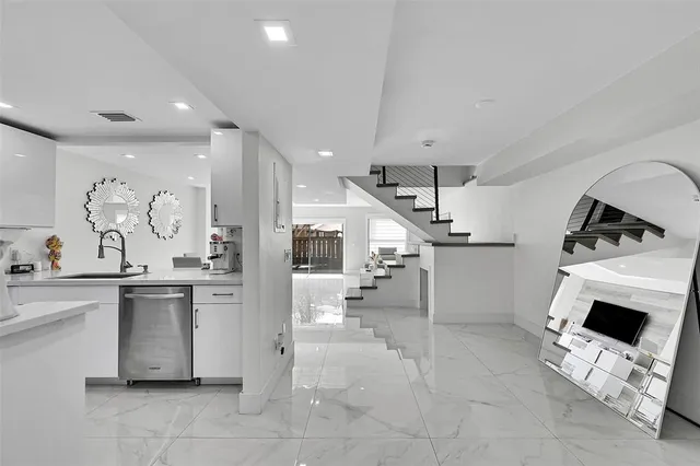 a kitchen with stainless steel appliances kitchen island granite countertop a sink and cabinets