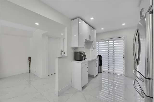 a kitchen with a refrigerator and a sink