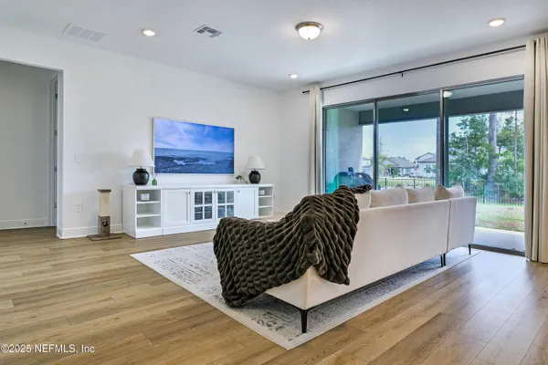 a living room with furniture and a large window